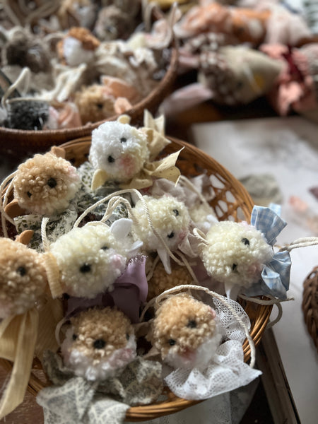 Decorative items resembling small animals with flowers in a woven basket.