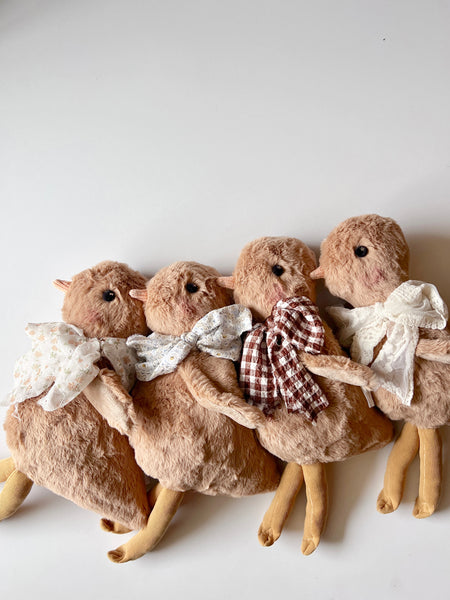 faux fur chick dolls with scarves on a light background