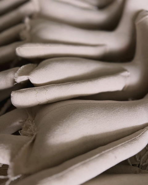 Close-up of  unicorn dolls stacked together.