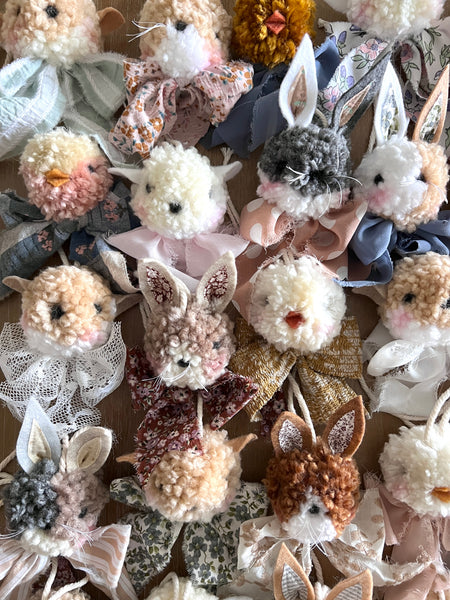 Collection of decorative bunny figurines with various colors and textures.