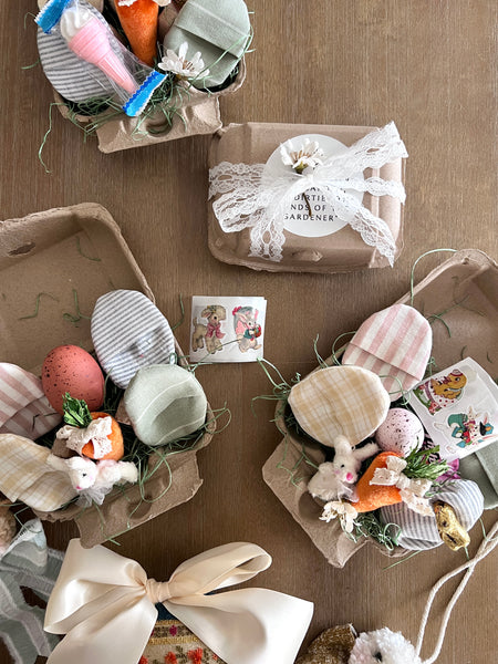 Decorative Easter eggs and baskets on a wooden surface with a card.
