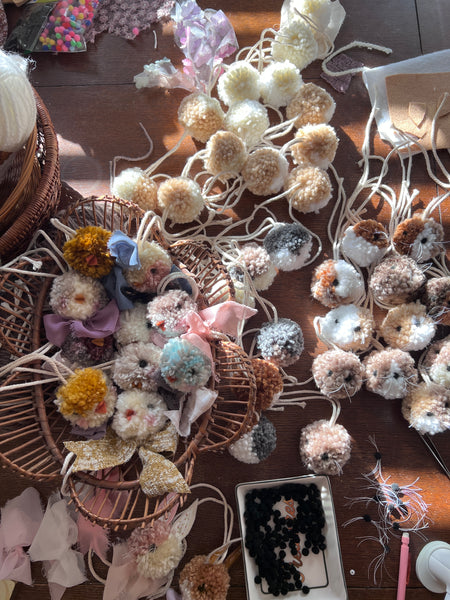 Assorted decorative items including flowers, ribbons, and small objects on a wooden surface.