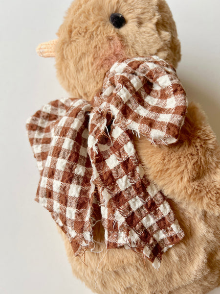 faux fur chick dolls with scarf on a light background