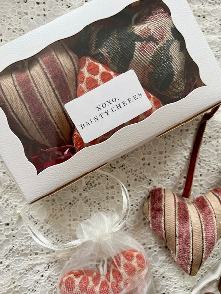 Heart-shaped products in a box with a label on a textured surface