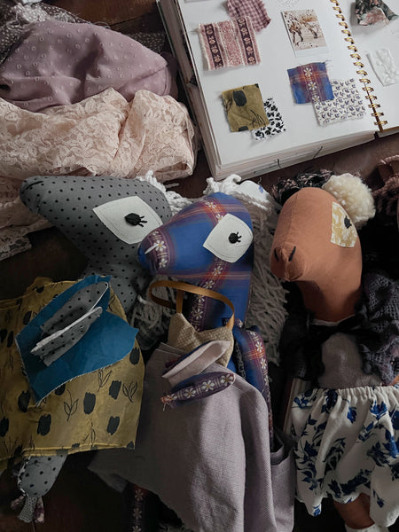 up close shot of 3 horse dolls on work table