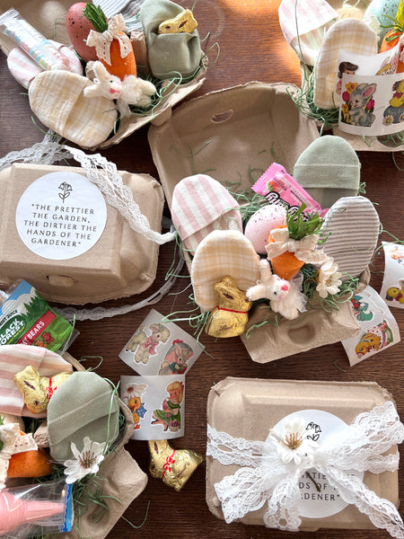 Decorative Easter egg cartons with small figurines and text on a wooden surface.