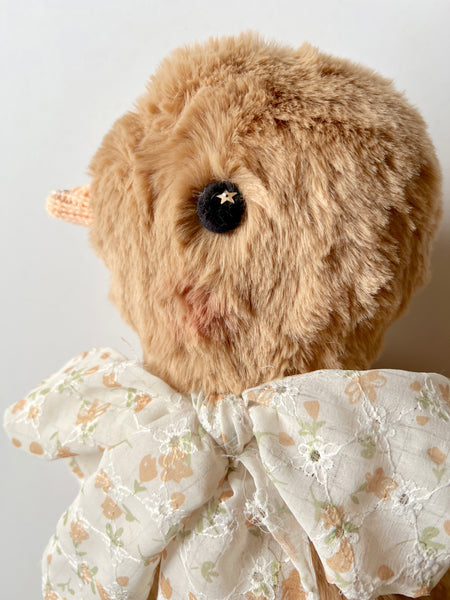 faux fur chick dolls with scarf on a light background