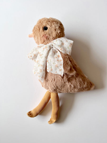 faux fur chick dolls with scarf on a light background